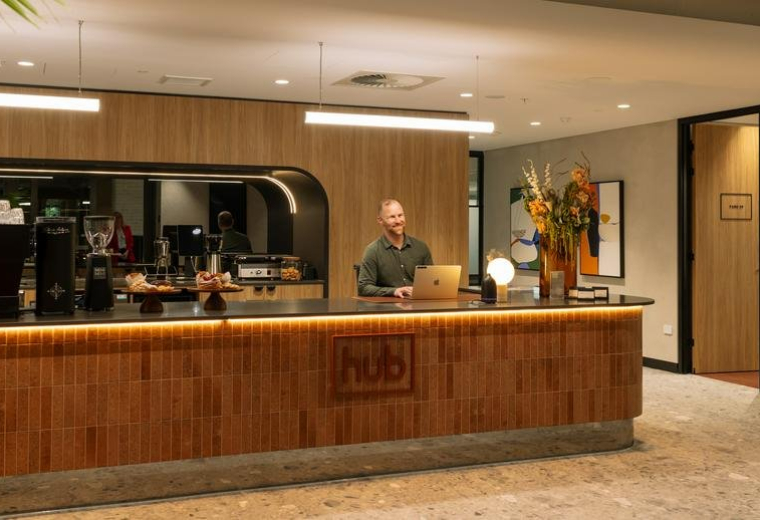 Reception area at 88 O’Connell Street, Adelaide, South Australia with a timber-slatted desk and warm lighting.