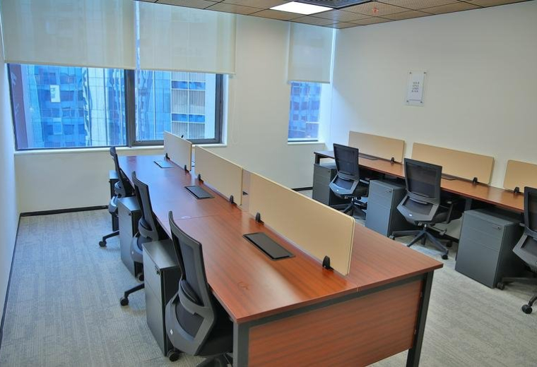 Modern white curved reception desk under a circular recessed ceiling light with wood paneling.
