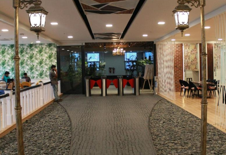 Spacious lobby at Western Aqua, HITEC City, Hyderabad, India featuring a stone path and street lamps.