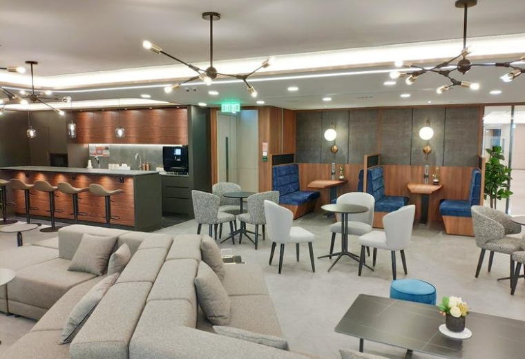 Spacious communal lounge with diverse seating, café bar, and designer lighting.
