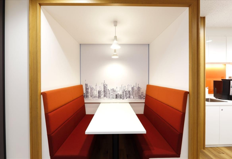 Meeting booth with orange tiered seating and a city skyline mural at Machida, 1-36-2, Morino, Tokyo.
