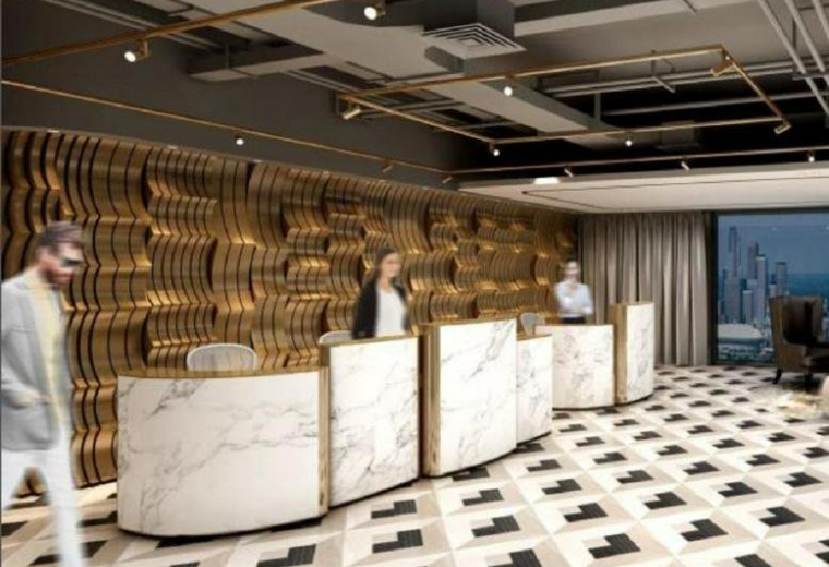 Grand reception lobby of Metropolitan Oriental Plaza featuring marble desks and a gold-toned wavy feature wall.