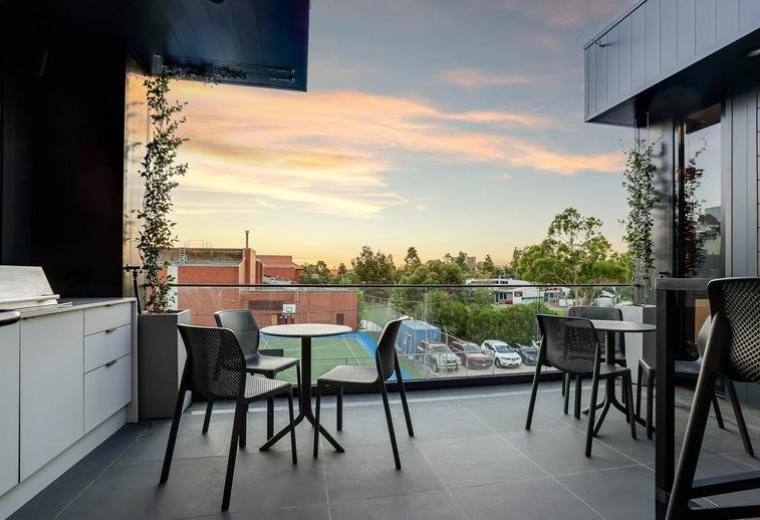 Rooftop terrace with outdoor seating and sunset views.