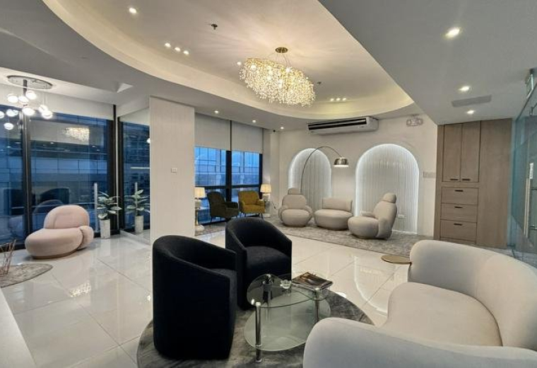 Elegant lounge area featuring curved sofas and circular grey rugs.