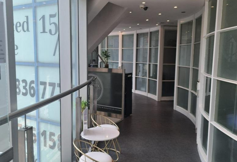 Bright, spacious reception area at 14/F-18/F Radio City with glass partitions and gold-trimmed chairs.