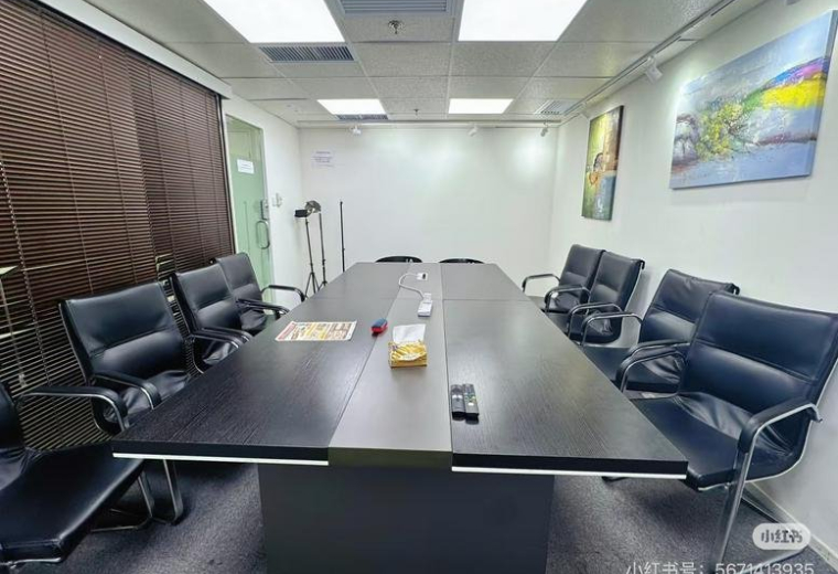 Meeting room at The Point, 14 科學館道 featuring a dark wood conference table and black leather chairs.