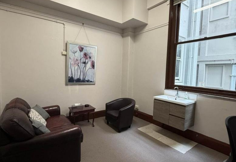Private office at 17, Bolton Street, Level 2, Suite 209 featuring a leather sofa, armchair, and vanity unit.