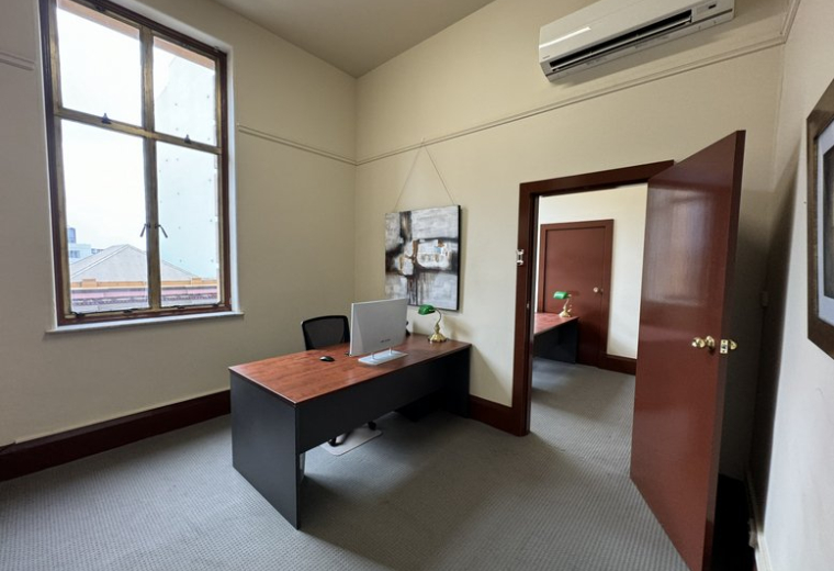 Spacious private office with a desk and large window at 17, Bolton Street, Level 3 Suite 306.
