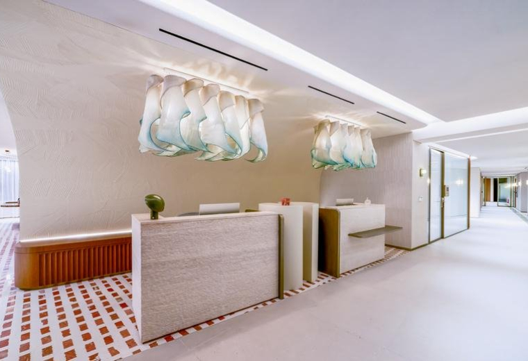 Spacious wood-paneled reception area at Levels 1, 2, 3, 4 & 5, Metro Blvd with custom glass art installations.