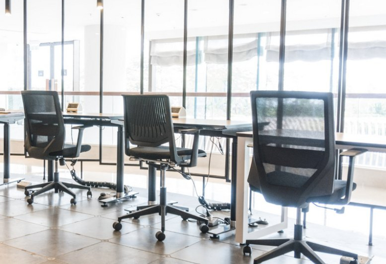 Sleek coworking area with black mesh chairs and glass partitions at Kerry Hotel Hong Kong, 2/F, 38 Hung Luen Road.