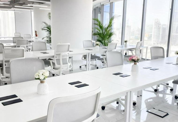 Exterior view of the Addax Tower in Abu Dhabi, a tall modern skyscraper with glass facade.