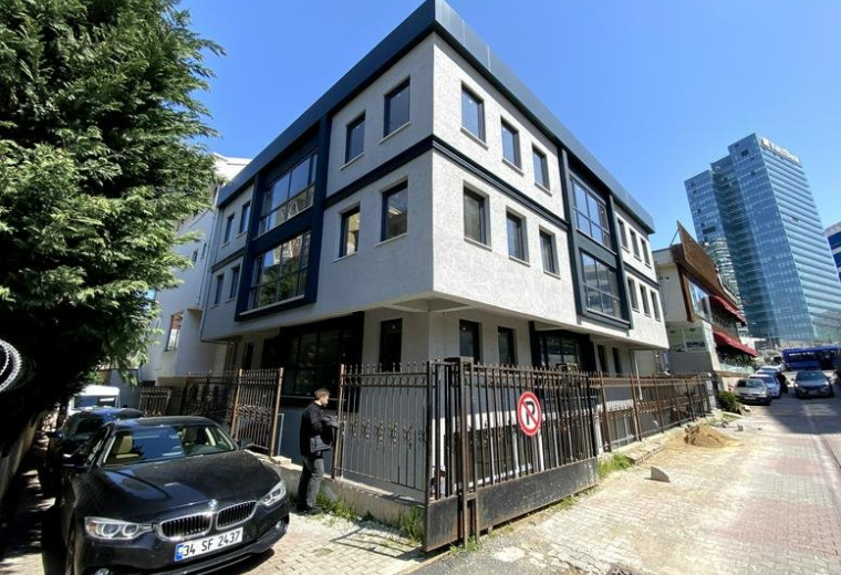Exterior view of the modern corner building at 4/1 Umman Sokak with grey and black facade.