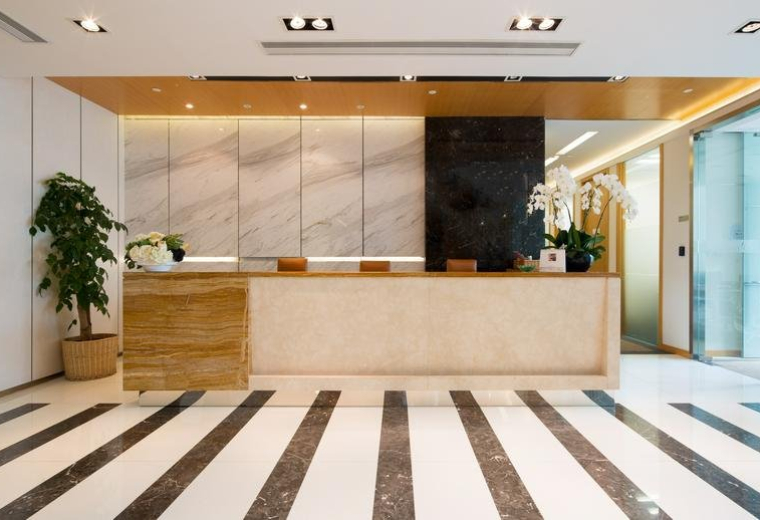 Sleek marble and wood reception area at Gubei International Financial Centre II.