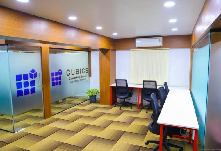 Bright coworking area at 860/A Narendra chambers West of chord road 2nd stage with glass offices and desks.
