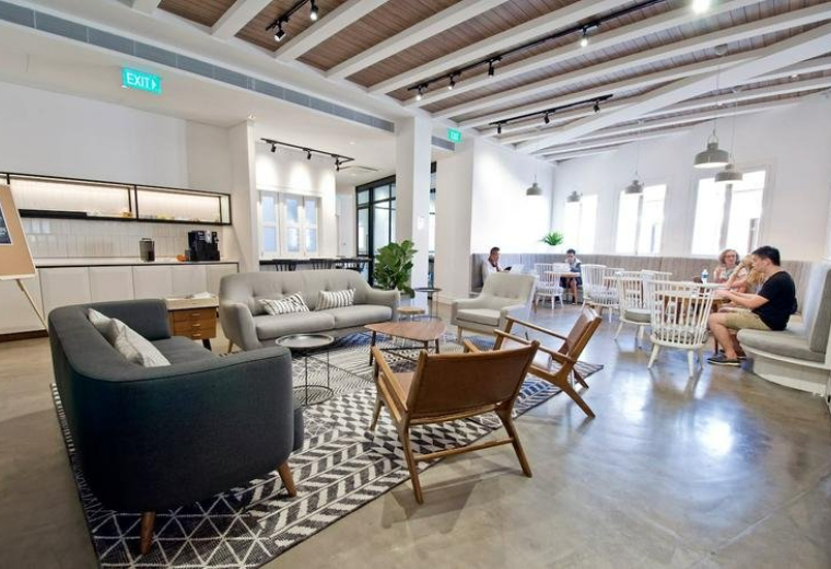 Spacious communal lounge and cafe area at 99 Duxton Road, Singapore with high beamed ceilings.