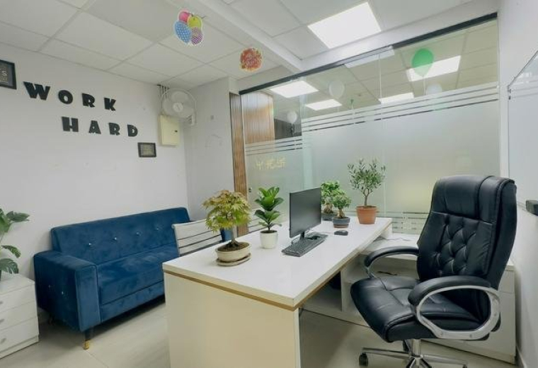 Bright private office at 5th floor 602 B2 Vasavi MPM Grand with a blue sofa and 'Work Hard' wall art.