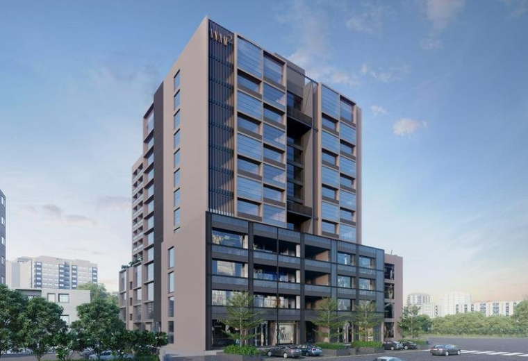 Exterior view of the modern multi-story commercial building Anam 2 with a sleek glass and dark panel facade.