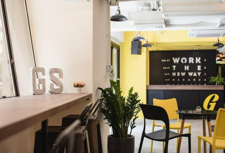 Modern reception area at Beverly House, 93-107 Lockhart Road, with yellow accents and brand signage.