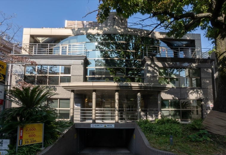 Exterior view of the contemporary Frances Building with a reflective glass and stone facade.