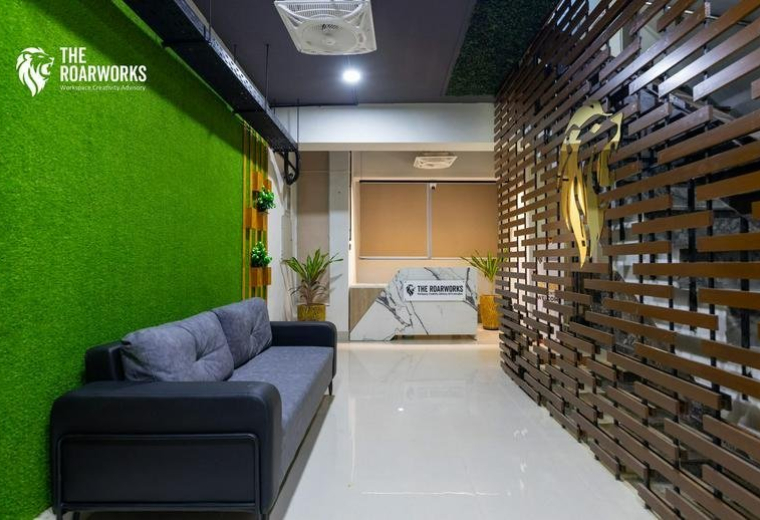 Modern reception lobby at Eagle Plaza, Blue Area, Islamabad, Pakistan with a green feature wall and wood paneling.