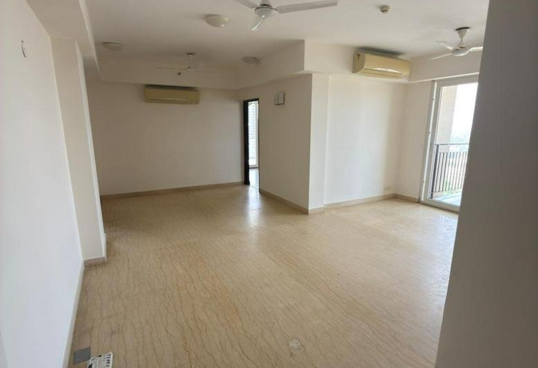 Extensive open-plan floor area with light wood flooring and ceiling fans.