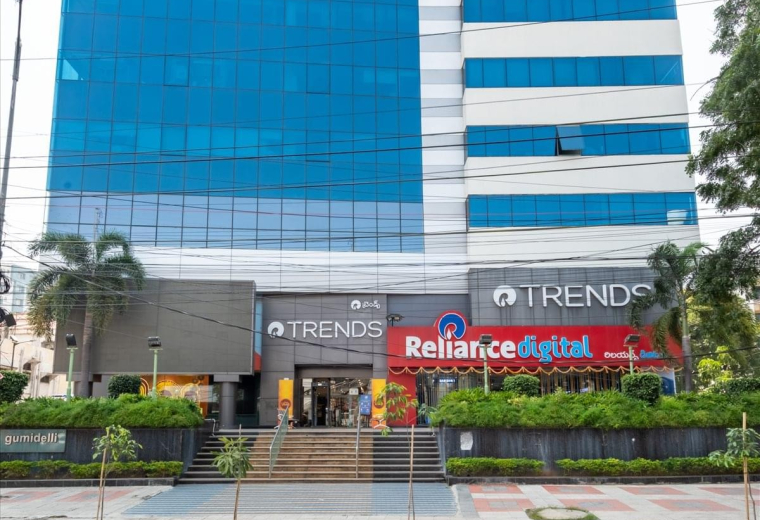Exterior view of the blue glass facade Gumidelli Commercial Complex on Old Airport Road.