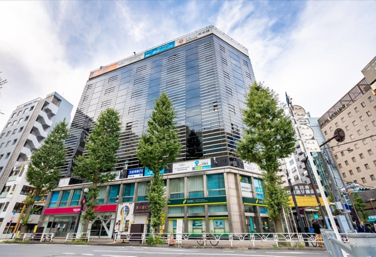 Exterior view of the glass-facade Humax Ebisu building in the city center.