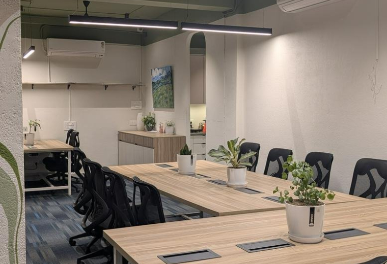 Spacious co-working area at ICICI Bank, 2nd Floor, Sai Enclave with wooden desks and indoor plants.