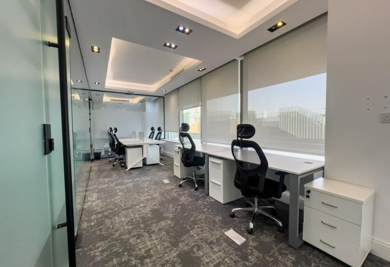 Open-plan office with multiple workstations and ergonomic chairs at KAFD, Building 3