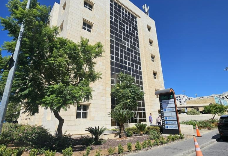 Exterior view of the stone-cladded KGBP, Building No 7 with a central glass facade.