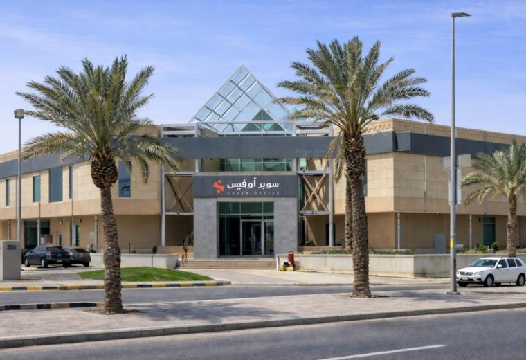 Exterior view of the modern Khurais Branch Road building featuring a distinct glass pyramid roof.