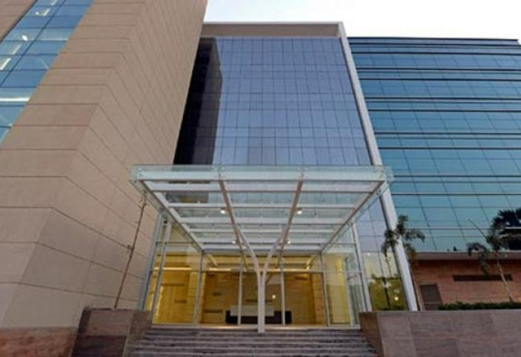 Exterior view of the glass-facade building at Plot No. D-3, Road Number 16, Wagle Industrial Estate.