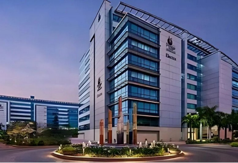 Exterior view of Redbrick Offices, Bangalore with modern glass facade and landscaped entrance.