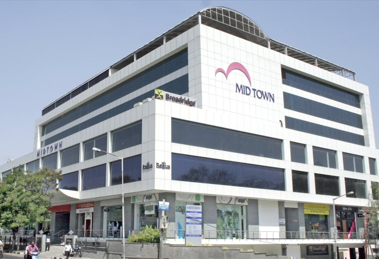 Exterior view of the white Mid Town building at Level 1, Road no 1, Banjara Hills.