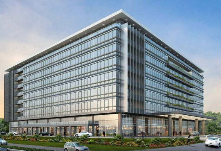 Exterior view of the glass-facade Poloroche Business Avenue with modern architecture and landscaping.