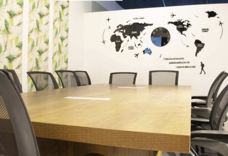 Spacious boardroom with a large wooden table and world map wall art at Tahliah Street.