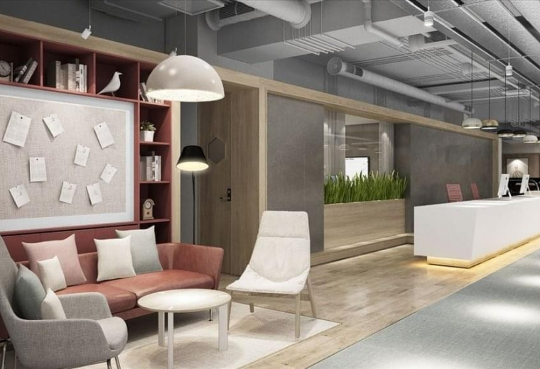 Bright reception area with a white marble desk, lounge seating, and built-in wooden shelving.