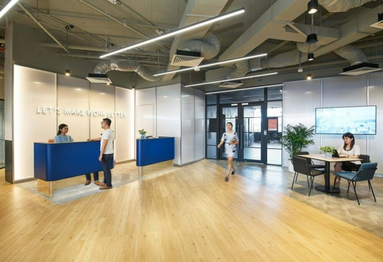 Reception and lobby area with blue desks at One North Crescent, Level 7, Singapore.