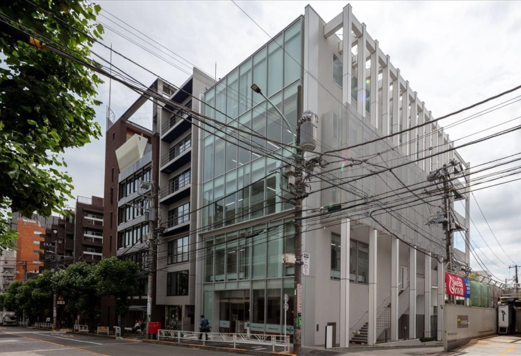 Exterior view of the modern glass and concrete facade of the Square Daikanyama building.