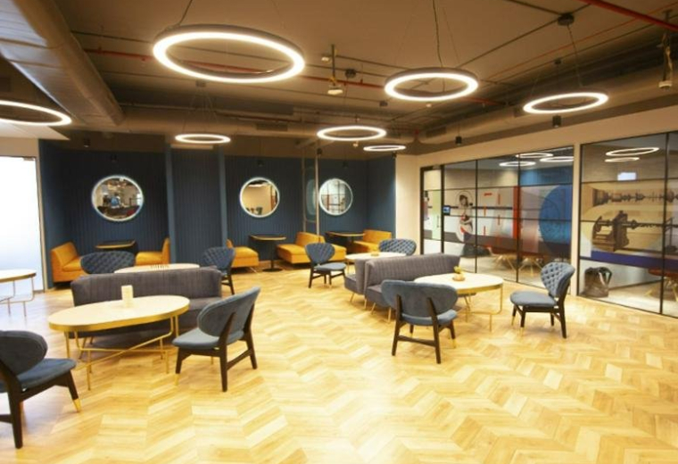 Spacious lounge area with wood floors and circular pendant lights at 1st – 4th Floor, Survey No 34, Kothaguda Junction.