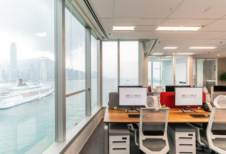Bright open-plan office at Tower 5, The Gateway with wooden desks and expansive views of Victoria Harbour.