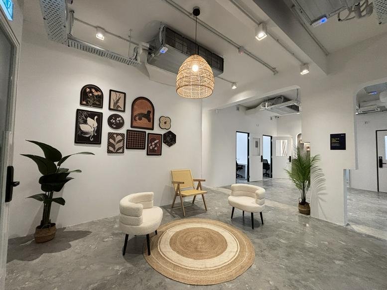 Spacious reception area at 11-1 & 11A-1, Jalan BSC 2C/5 with botanical wall art, plants, and a wicker pendant light.