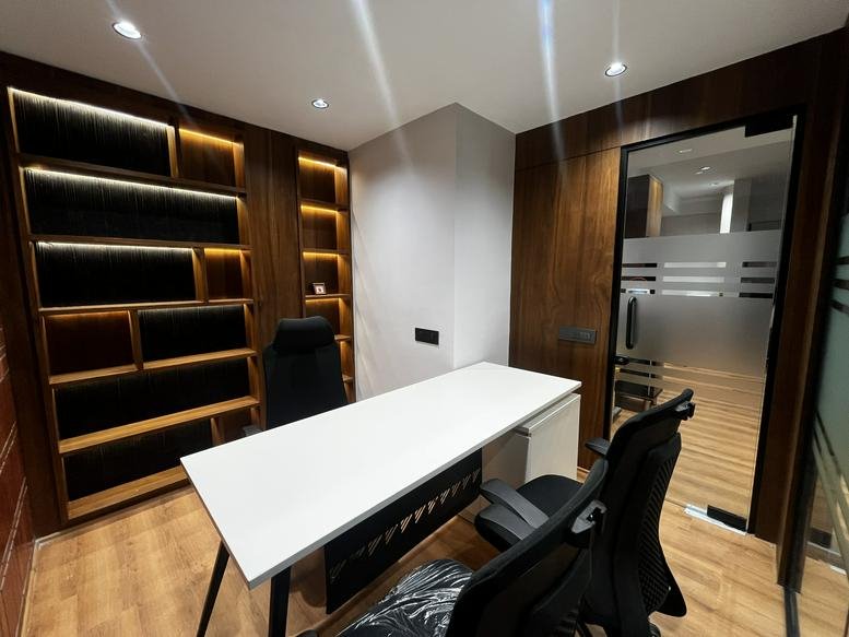 Private executive office with dark wood shelving and a white desk at STC building nr vakilbridge Ambli-bopal road.