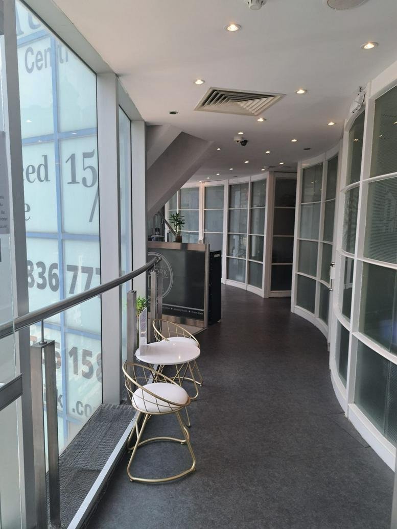 Bright, spacious reception area at 14/F-18/F Radio City with glass partitions and gold-trimmed chairs.