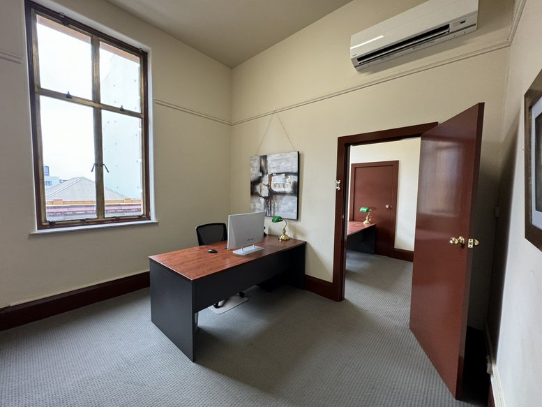 Spacious private office with a desk and large window at 17, Bolton Street, Level 3 Suite 306.