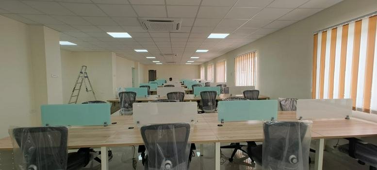 Spacious open-plan office workspace at 20/A31, Sipcot IT park with rows of modern desks and ergonomic chairs.