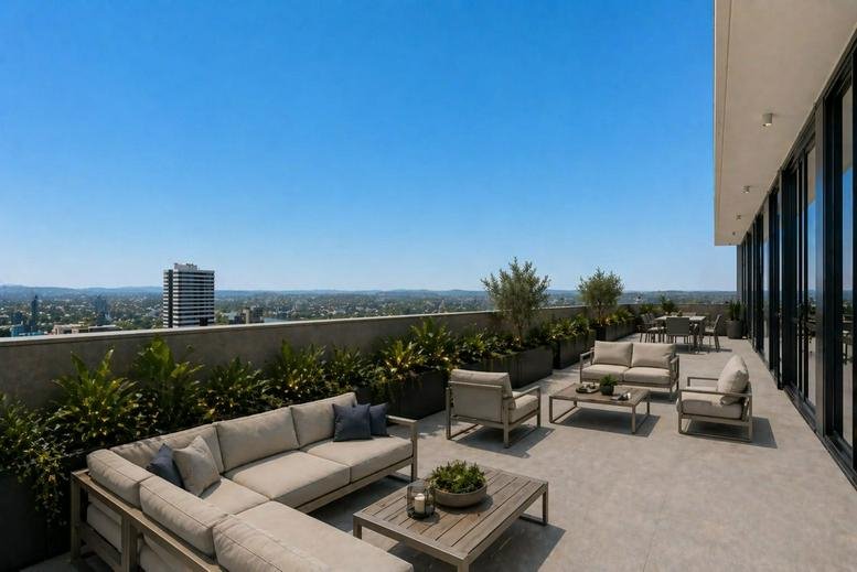 Large outdoor terrace with comfortable sofa seating and panoramic city views.