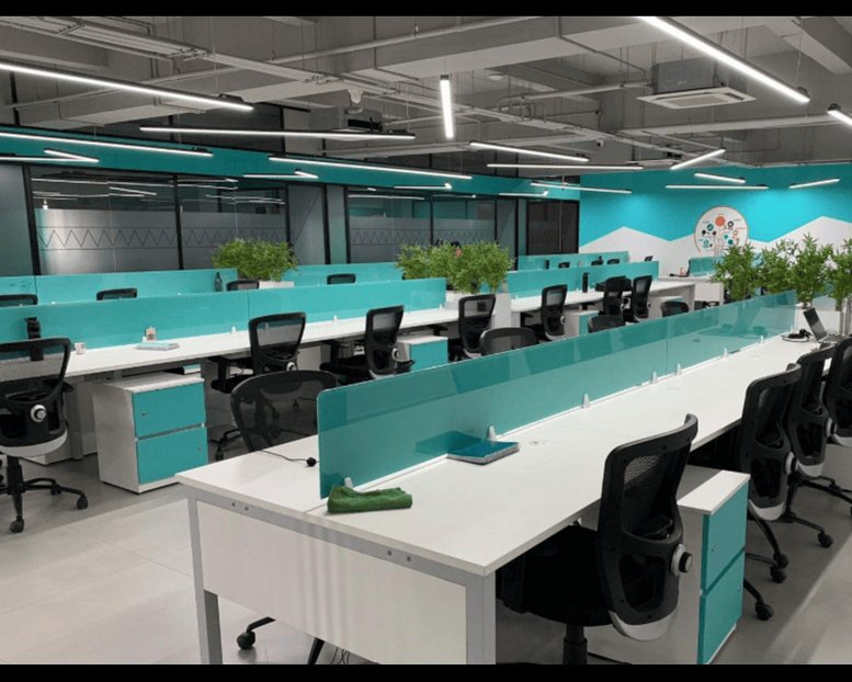 Spacious open-plan workspace at 2224/3, Trichy Road with teal accents and indoor plants.