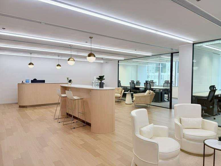 Spacious reception lounge at 27/F, 1111 King's Road, Taikoo Shing featuring warm wood floors and white seating.