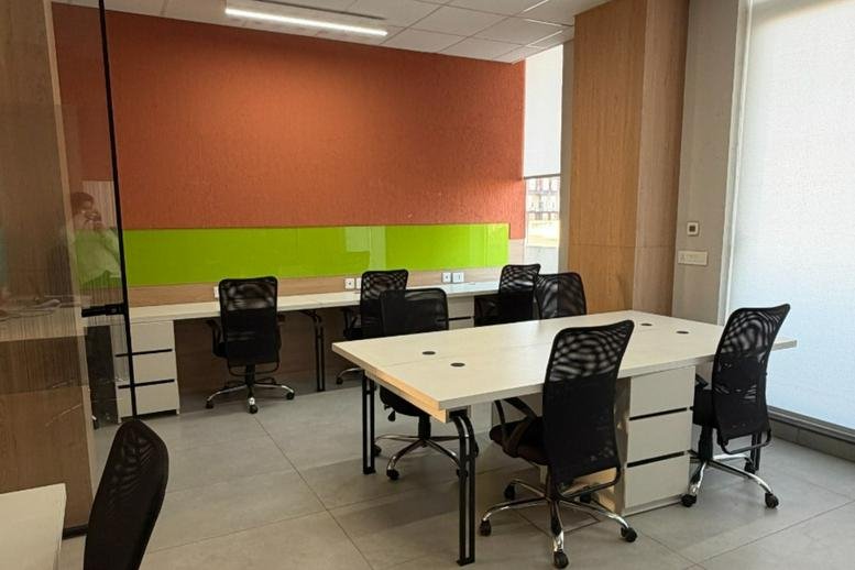 Bright office space at 3rd Floor, D-231, Phase 8B, Sector 91 with white desks and orange feature wall.